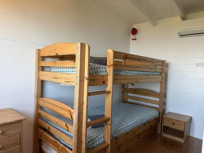 a room with two bunk beds in a room at La Colline by Pinarello Villa Services in Fautea