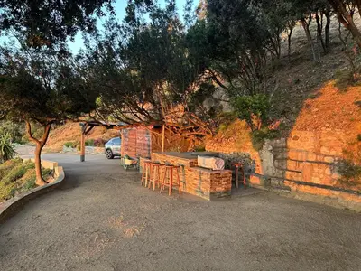 a brick building with tables and chairs in a parking lot at La Colline by Pinarello Villa Services in Fautea