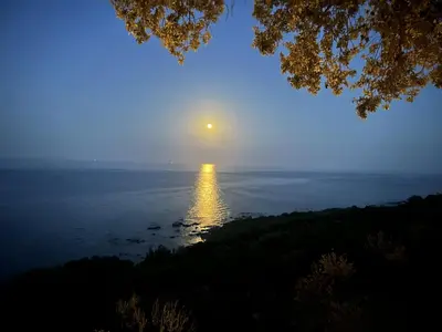 a view of the ocean at night at La Colline by Pinarello Villa Services in Fautea