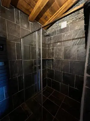 a shower with a glass door in a bathroom at Bergerie in Volpajola