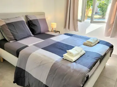 a bedroom with a bed with two towels on it at Villa Poggiole in San-Nicolao
