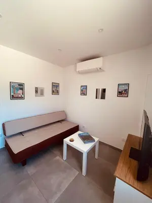 a living room with a couch and a table at Villa Poggiole in San-Nicolao