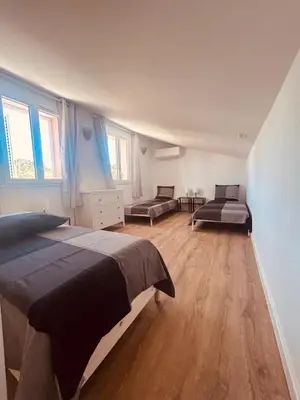 a bedroom with two beds and a dresser at Villa Poggiole in San-Nicolao