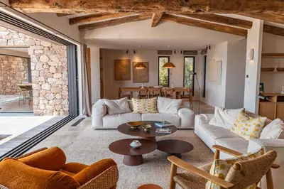 a living room with a couch and a table at Villa Bonanza Di Cala Rossa in Lecci