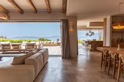 a living room with a couch and a table at Villa Bonanza Di Cala Rossa in Lecci