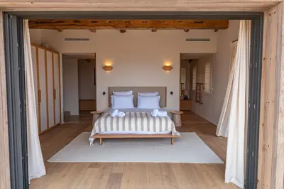 a bedroom with a bed with white pillows at Villa Bonanza Di Cala Rossa in Lecci