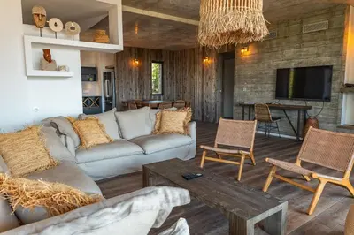 a living room with a couch and a table at Villa Fautea Di Santa Lucia in Sainte-Lucie de Porto-Vecchio