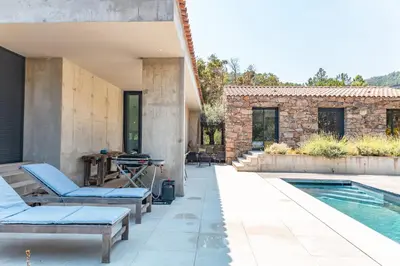 a patio with a swimming pool and a house at Villa Cupulatta Di Santa Lucia in Sainte-Lucie de Porto-Vecchio