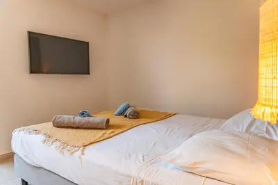 a bedroom with a bed with two towels on it at Villa Cupulatta Di Santa Lucia in Sainte-Lucie de Porto-Vecchio