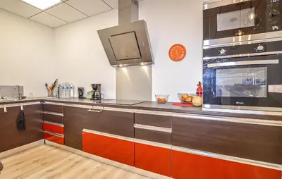 a kitchen with wooden cabinets and a stove top oven at 2 Bedroom Cozy Apartment In Prunete in Prunete