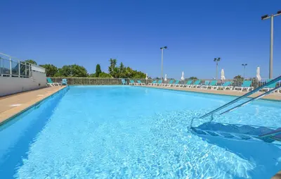 a large swimming pool with blue water at 2 Bedroom Cozy Apartment In Prunete in Prunete
