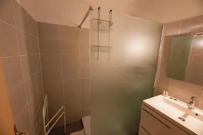 a bathroom with a sink and a shower with a mirror at Casa l'Ascosu 2 in Coggia