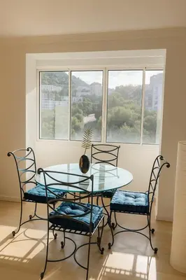 a dining room with a glass table and two chairs at Evasion Méditerranée - Vue Mer in Ajaccio
