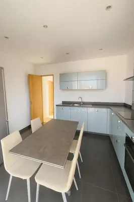 a kitchen with a table and chairs in it at Evasion Méditerranée - Vue Mer in Ajaccio