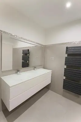 a bathroom with a white sink and a mirror at Evasion Méditerranée - Vue Mer in Ajaccio