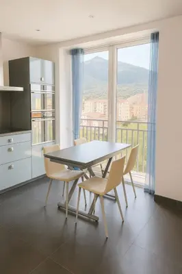a kitchen with a table and chairs and a large window at Evasion Méditerranée - Vue Mer in Ajaccio