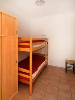 a room with two bunk beds and a cabinet at Résidence Ellada 3 Appartement 12 in Cargèse