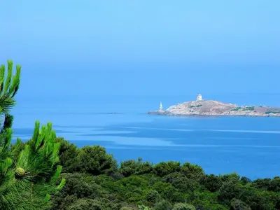 a lighthouse on an island in the middle of the ocean at Résidence Ellada 3 Appartement 12 in Cargèse