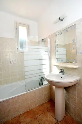 a bathroom with a sink and a bath tub at Résidence Ellada 3 Appartement 12 in Cargèse