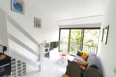 a living room with a couch and a table at Studio with sea view in Calcatoggio
