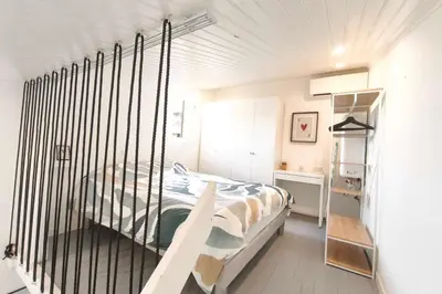 a bedroom with a zebra print bed and a shelf at Studio with sea view in Calcatoggio