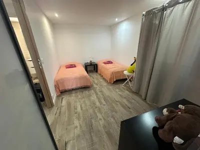 a room with two beds and two teddy bears at Appartement proche de la rivière et de la plage ! in Vico