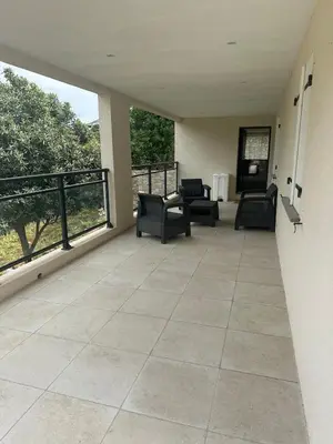 a large patio with chairs and tables on a balcony at Appartement proche de la rivière et de la plage ! in Vico