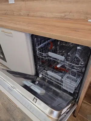 an open dishwasher with tools inside of it at Appartement T2 moderne 2 à 4 personnes in Lucciana