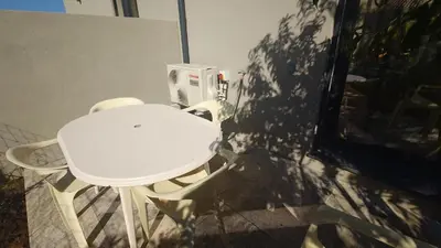 a white table and chairs in a room at Appartement T2 moderne 2 à 4 personnes in Lucciana