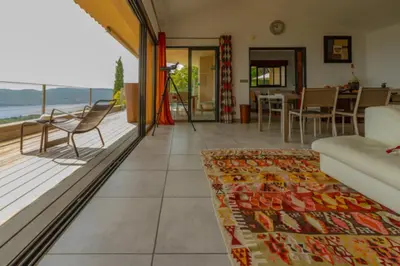 a living room with a view of the ocean at Villa Panorama Porto-Vecchio in Porto-Vecchio