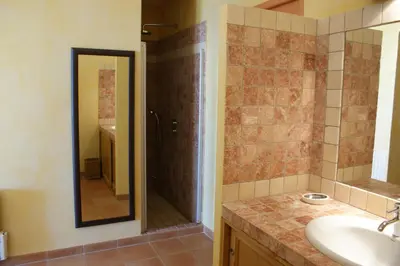 a bathroom with a shower and a sink and a mirror at Villa Panorama Porto-Vecchio in Porto-Vecchio