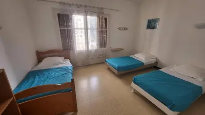 a room with two beds and a window at Grand appartement Vescovato entre mer et montagne in Vescovato
