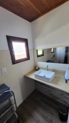a bathroom with a white sink and a mirror at Grand appartement Vescovato entre mer et montagne in Vescovato