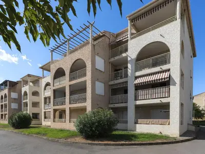 an apartment building with balconies on the side of it at Apartment Albarella by Interhome in Vescovato