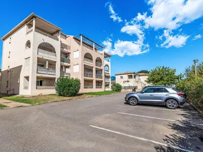 a car parked in a parking lot in front of a building at Apartment Albarella by Interhome in Vescovato