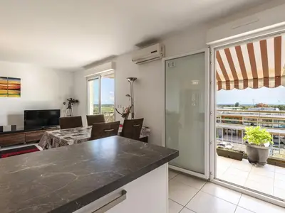 a kitchen and living room with a view at Apartment Albarella by Interhome in Vescovato