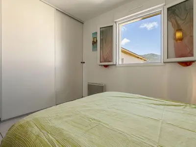 a bedroom with a bed and a window at Apartment Albarella by Interhome in Vescovato
