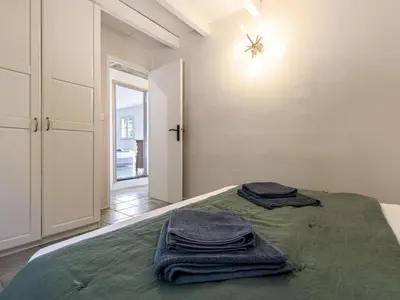 a bedroom with a bed with two towels on it at Holiday Home Casa Murato by Interhome in San-Giuliano