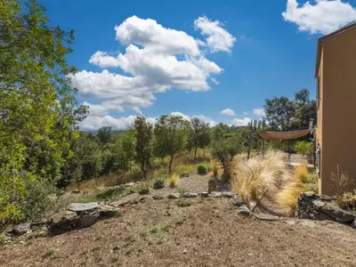 a view of a field with trees and a house at Holiday Home Casa Murato by Interhome in San-Giuliano