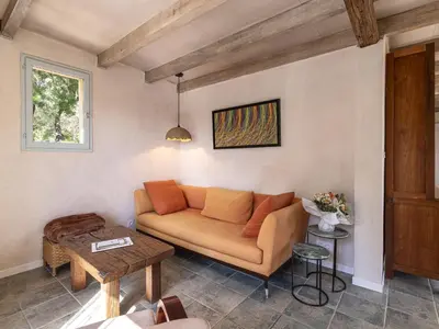 a living room with a couch and a table at Holiday Home Casa Murato by Interhome in San-Giuliano