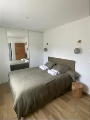 a bedroom with a large bed and a bathroom at Villa 4 chambres à Castirla in Castirla