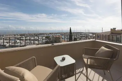 a balcony with chairs and a view of the ocean at Hôtel & Spa Best Western Premier A Storia Solenzara in Sari Solenzara