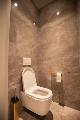 a bathroom with a white toilet in a room at Villa Lucia Di Arinella in Pinarellu