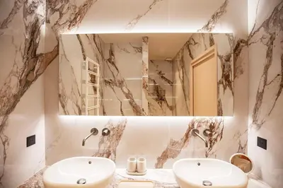 a bathroom with a sink and a mirror at Villa Lucia Di Arinella in Pinarellu