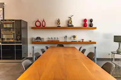 a conference room with a wooden table and chairs at Casa Carolina Di Palombaggia in Porto-Vecchio