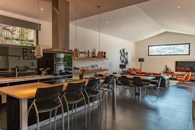 an open kitchen with wooden tables and chairs at Casa Carolina Di Palombaggia in Porto-Vecchio
