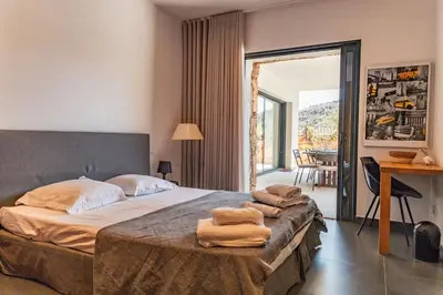 a bedroom with a bed with towels on it at Casa Carolina Di Palombaggia in Porto-Vecchio