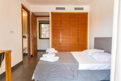 a bedroom with a bed with towels on it at Casa Carolina Di Palombaggia in Porto-Vecchio