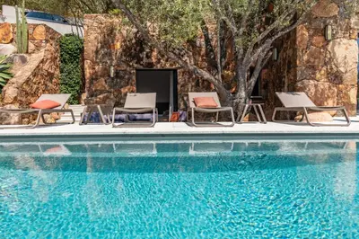 a group of chairs and a swimming pool at Casa Carolina Di Palombaggia in Porto-Vecchio