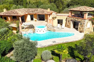 an aerial view of a house with a swimming pool at Villa Domaine de Pinarello in Pinarellu